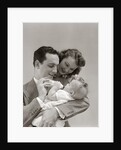 1940s Father Cradling Baby Daughter Feeding Her Bottle With Mother Looking Over His Shoulder by Anonymous