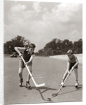 1930s 1940s 2 Boys With Sticks And Puck Wearing Roller Skates Playing Street Hockey by Anonymous