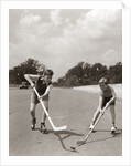 1930s 1940s 2 Boys With Sticks And Puck Wearing Roller Skates Playing Street Hockey by Anonymous