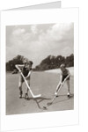 1930s 1940s 2 Boys With Sticks And Puck Wearing Roller Skates Playing Street Hockey by Anonymous