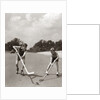 1930s 1940s 2 Boys With Sticks And Puck Wearing Roller Skates Playing Street Hockey by Anonymous