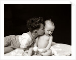 1940s Curly Haired Boy Toddler Leaning And Kissing Cute Baby by Anonymous