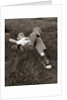 1960s Boy Sleeping In Grass Legs Crossed Holes In Sneakers Baseball Mitt By His Side by Anonymous