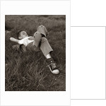 1960s Boy Sleeping In Grass Legs Crossed Holes In Sneakers Baseball Mitt By His Side by Anonymous