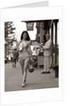 1970s Man Ogling Sexy Young Woman Walking Down City Street Wearing Only A Bikini by Anonymous
