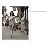 1970s Man Ogling Sexy Young Woman Walking Down City Street Wearing Only A Bikini by Anonymous