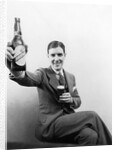 1920s 1930s Man Holding Up Huge Distorted Beer Bottle In One Hand And A Regular Size Glass Of Beer In Other by Anonymous