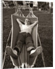 1950s Relaxed Boy Lying In Suburban Backyard Hammock by Anonymous