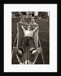 1950s Relaxed Boy Lying In Suburban Backyard Hammock by Anonymous