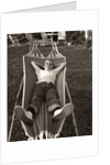 1950s Relaxed Boy Lying In Suburban Backyard Hammock by Anonymous