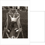 1950s Relaxed Boy Lying In Suburban Backyard Hammock by Anonymous