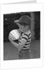 1950s Side View Of Boy In Baseball Cap and Striped T-Shirt Blowing Up Swirled Balloon by Anonymous