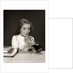 1950s 1960s School Girl Using Straw Drinking Carbonated Beverage From Bottle by Anonymous