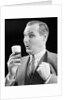 1930s Man Holding Full Foamy Glass Of Beer Making A Funny Face With His Thumb Hooked Confidently Under His Vest by Anonymous