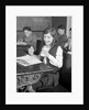 1920s School Girl Eating Lunch At Her Desk Drinking From A Bottle Of Milk Holding A Sandwich by Anonymous