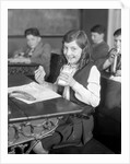1920s School Girl Eating Lunch At Her Desk Drinking From A Bottle Of Milk Holding A Sandwich by Anonymous