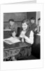 1920s School Girl Eating Lunch At Her Desk Drinking From A Bottle Of Milk Holding A Sandwich by Anonymous