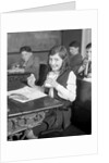 1920s School Girl Eating Lunch At Her Desk Drinking From A Bottle Of Milk Holding A Sandwich by Anonymous