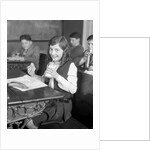 1920s School Girl Eating Lunch At Her Desk Drinking From A Bottle Of Milk Holding A Sandwich by Anonymous