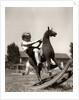 Little Boy on Rocking Horse Toy by Anonymous