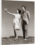 1940s Teenage Couple Standing Together Outdoors Girl Pointing by Anonymous