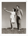 1940s Teenage Couple Standing Together Outdoors Girl Pointing by Anonymous