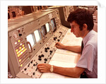 1970s Man Sitting At Control Panel Of NASA Mission Control by Anonymous