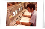 1970s Man Sitting At Control Panel Of NASA Mission Control by Anonymous
