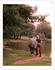 1970s 1960s Two Boys Walking Beside Fishing Pond by Anonymous