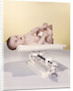 1950s 1960s Baby Lying On Weight Scale by Anonymous