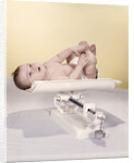 1950s 1960s Baby Lying On Weight Scale by Anonymous