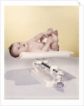 1950s 1960s Baby Lying On Weight Scale by Anonymous