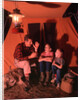 1960s 1970s Grandfather Telling Scary Story To Boys By Tent At Night Campsite In Shadows by Anonymous