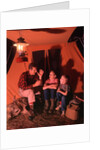 1960s 1970s Grandfather Telling Scary Story To Boys By Tent At Night Campsite In Shadows by Anonymous