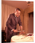 1960s Well-Dressed Man Carving Roast Beef At Dinner Table by Anonymous