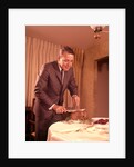1960s Well-Dressed Man Carving Roast Beef At Dinner Table by Anonymous