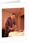 1960s Well-Dressed Man Carving Roast Beef At Dinner Table by Anonymous