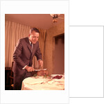 1960s Well-Dressed Man Carving Roast Beef At Dinner Table by Anonymous