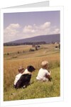 1960s Back Of Two Boys With Black And White Dog Sitting Hillside Field Looking Down To Farm by Anonymous