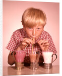 1950s 1960s Boy Drinking Three Milkshakes Through A Straw At Same Time by Anonymous