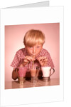 1950s 1960s Boy Drinking Three Milkshakes Through A Straw At Same Time by Anonymous