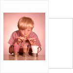 1950s 1960s Boy Drinking Three Milkshakes Through A Straw At Same Time by Anonymous
