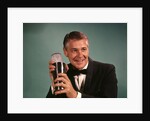 1960s 1970s Bartender Man In Black Tuxedo Mixing Cocktail In Shaker by Anonymous
