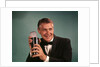 1960s 1970s Bartender Man In Black Tuxedo Mixing Cocktail In Shaker by Anonymous