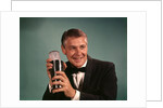 1960s 1970s Bartender Man In Black Tuxedo Mixing Cocktail In Shaker by Anonymous