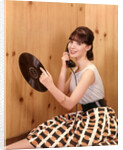 1950s Teenage Girl Talking On Telephone And Holding LP Record by Anonymous