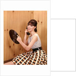 1950s Teenage Girl Talking On Telephone And Holding LP Record by Anonymous