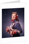 1960s Young Woman Wearing Red Mittens Ear Muffs Blue Sweater Holding Ice Skates In Falling Snow by Anonymous