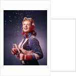 1960s Young Woman Wearing Red Mittens Ear Muffs Blue Sweater Holding Ice Skates In Falling Snow by Anonymous