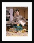 1960s Woman Housewife Mother Wearing Apron In Kitchen Pouring Milk Into Thermos For School Lunch by Anonymous